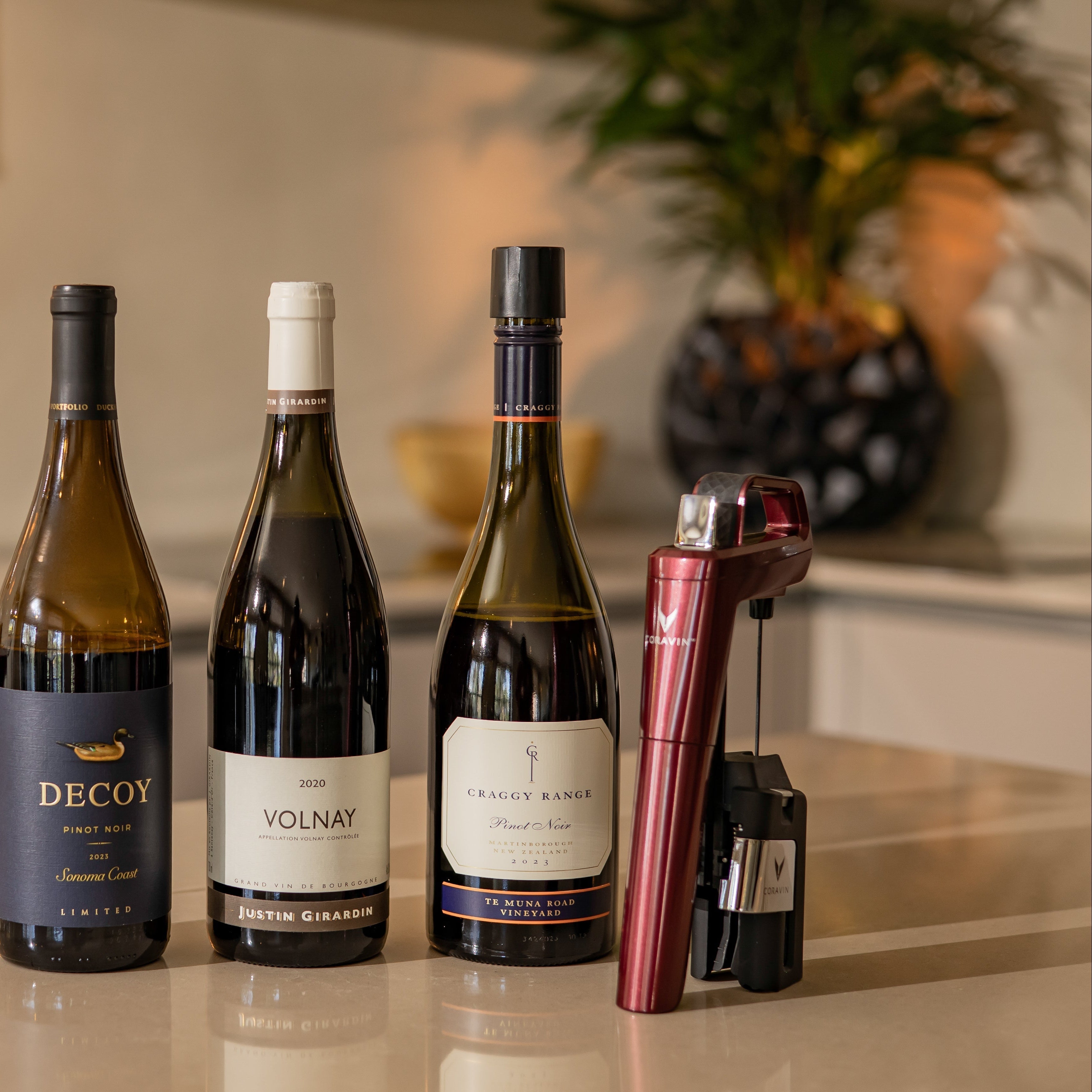 coravin with three bottles of pinot noir