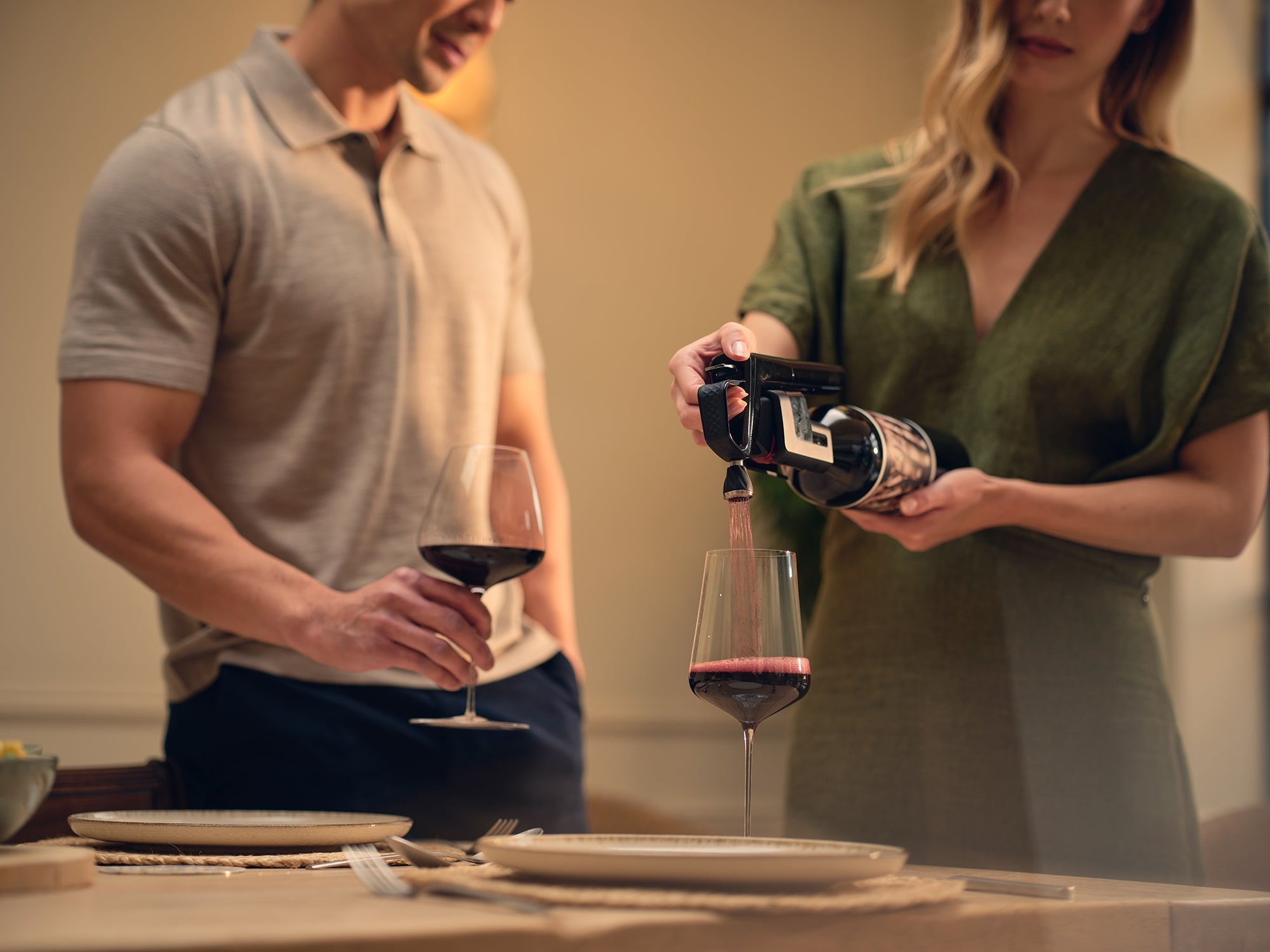 a couple with coravin wine preservation system pouring red wine