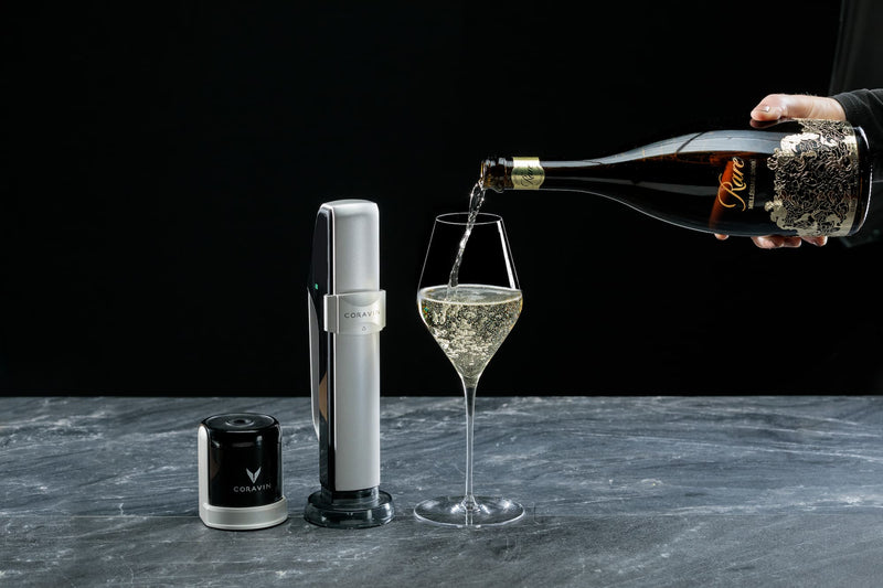 wine enthusiast pouring champagne with coravin sparkling system