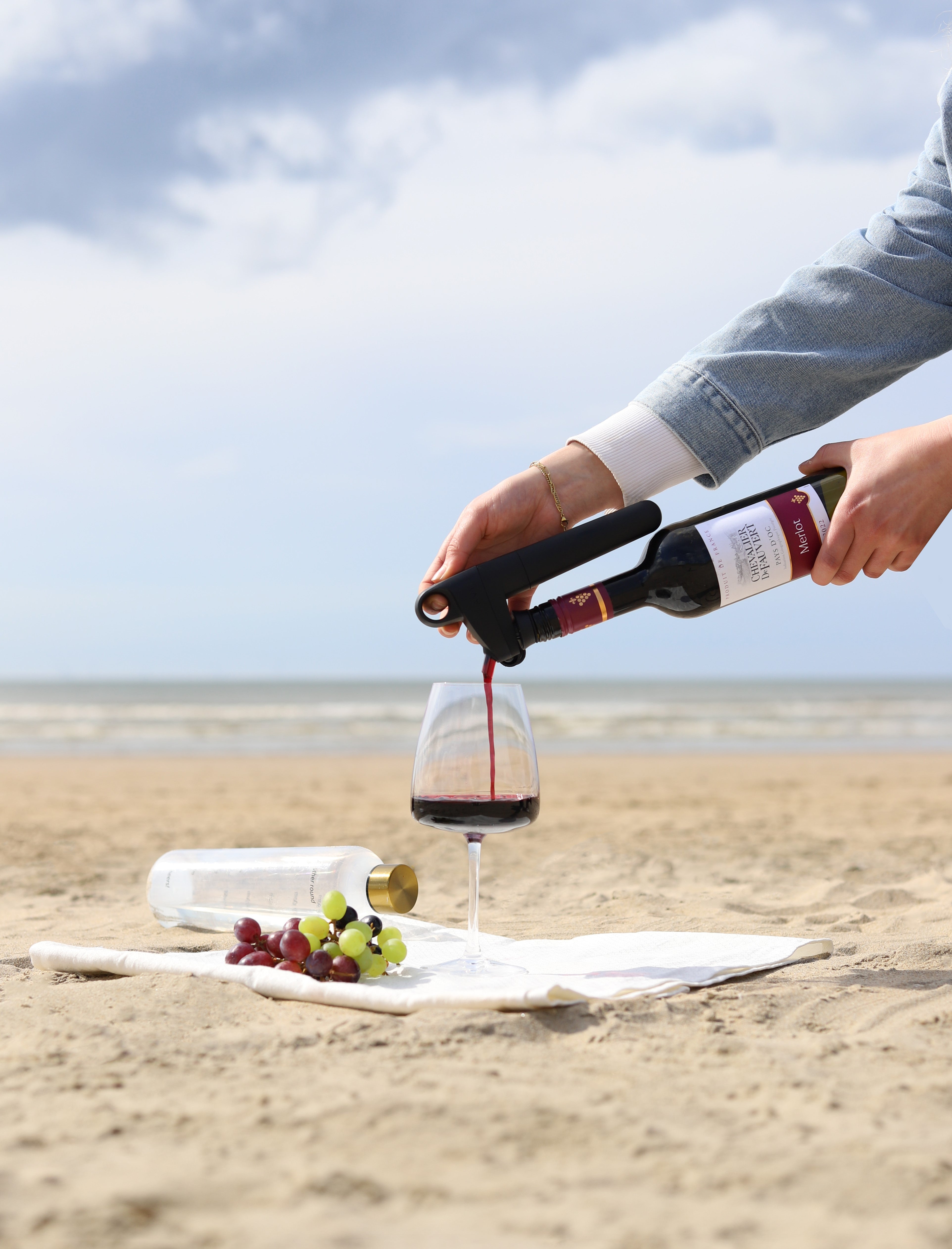 coravin pivot wine saver system on the beach pouring red wine